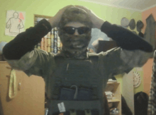 a man wearing sunglasses and a mask holds his hands to his head