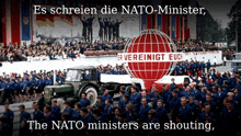 a large group of people are marching in front of a sign that says " es schreien die nato-minister "