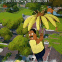 a man in a yellow shirt is holding a bunch of bananas in his hand .