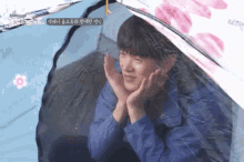 a young man is sitting in a tent with his hands on his face