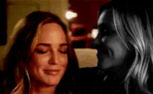 a couple of women are looking at each other in a room .