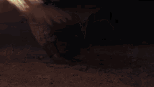 a man laying on the ground with a flame coming out of his mouth