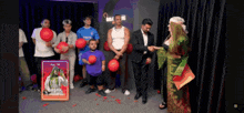 a group of people standing around a card that says basak on it