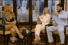 three people are sitting in chairs on a show called kelly