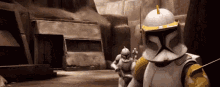 two clone trooper soldiers are standing next to each other on a dirt road .