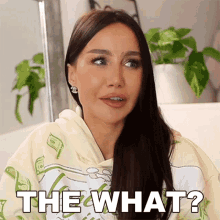 a woman is wearing a hoodie that says " the what "