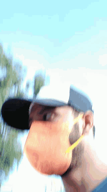 a blurry photo of a man wearing sunglasses and a hat