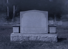 an empty grave in a cemetery with trees in the background .