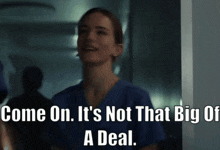 a woman in a blue scrub top is smiling and says come on it 's not that big of a deal
