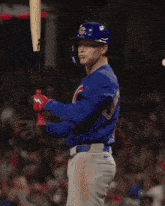 a baseball player wearing a blue shirt that says cubs on it