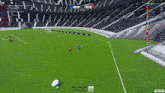 a soccer game is being played in a stadium and the score is 1-0