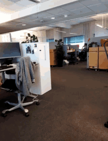an empty office with a sweater on a chair