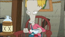 a cartoon character sits in a chair next to a bottle that says xxx