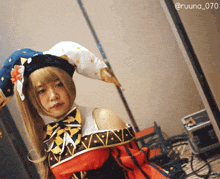 a girl in a clown costume with the hashtag @ruuna_070 on the bottom