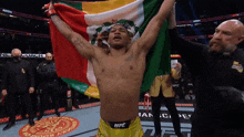 a man in a ufc shorts holds a mexican flag