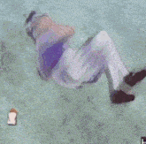 a cartoon character is laying on their back on a wooden floor .