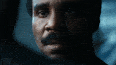 a close up of a man 's face with the word devour written below him