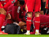 a soccer player in red socks with lfc on them