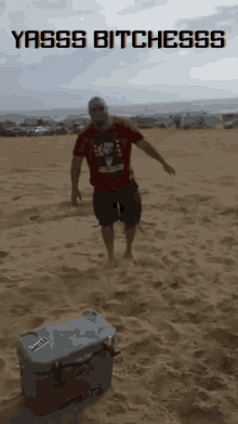 a man standing on a beach with the words yasss bitchesss above him