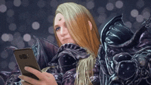 a woman with long hair is holding a cell phone in her hand .