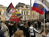 a group of people holding up flags one of which says " pogcia "