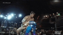 a wrestling match is being shown on a screen that says gcw