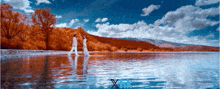 a couple walking across a body of water with a blue x in the bottom right