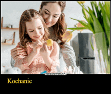 a picture of a woman holding a little girl with the word kochanie underneath it