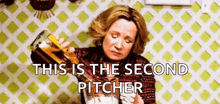 a woman is pouring a drink into a glass with the words `` this is the second pitcher '' written above her .