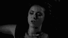 a black and white photo of a woman with the words am i in hell below her