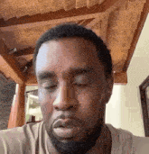 a close up of a man 's face with his eyes closed and a beard .