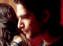a man and a woman are hugging and kissing each other .