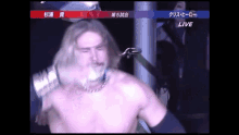 a man without a shirt is standing in front of a sign that says live on it