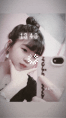 a girl is taking a picture of herself in a mirror with the numbers 1343 on her head