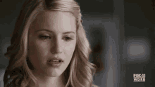 a woman is crying with a tear running down her face .
