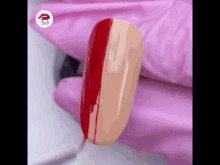 a close up of a nail being painted with a red stripe