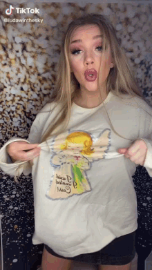 a woman is wearing a shirt that says tiktok on the bottom