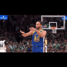a basketball player in a golden state warriors uniform stands in front of a crowd
