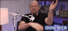 a man is sitting in front of a microphone with the words dark web written on the bottom