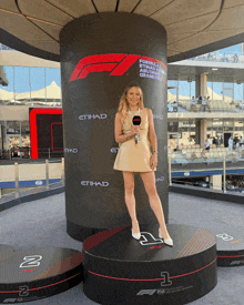 a woman is standing in front of a podium that says etihad on it