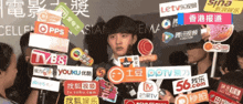 a man is surrounded by a bunch of chinese advertisements including one for tvb8