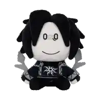 a black and white stuffed animal with a face that says ' o ' on it