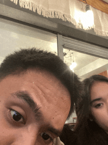 a man and a woman are posing for a picture together