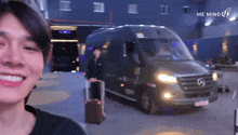 a man is smiling in front of a van that says me mind on it