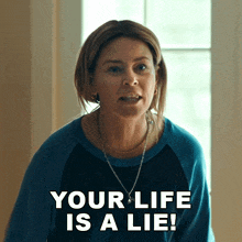 a woman says your life is a lie while wearing a blue shirt