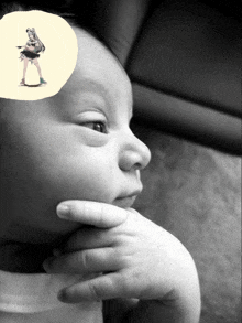 a black and white photo of a baby 's face with a picture of a woman on it