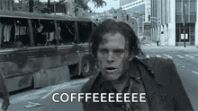a zombie is running down a city street with a bus in the background and says `` coffee '' .