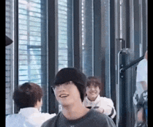 a group of people are standing next to each other in a room .