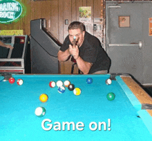 a man playing pool with the words game on in the corner