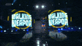 a walking weapon sign is on a stage with a wrestler